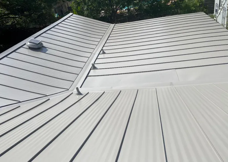 Solar attic fan installed on a metal roof for Roof Ventilation in Woodlake